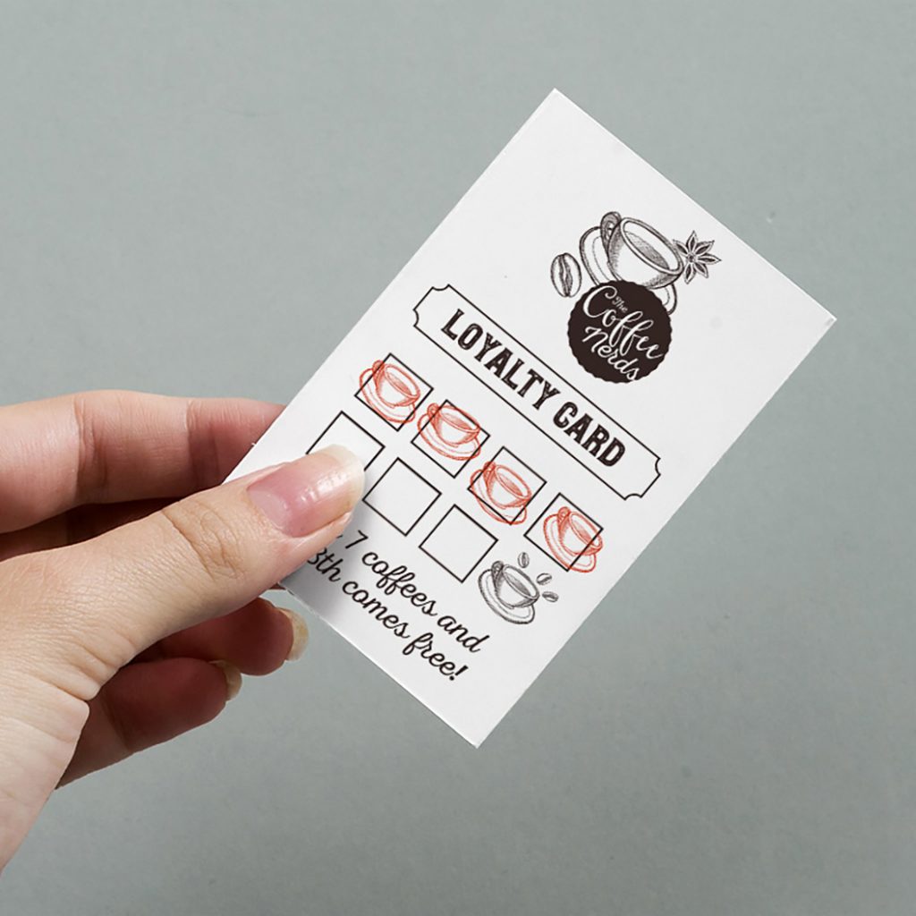 Uncoated loyalty card held in hand